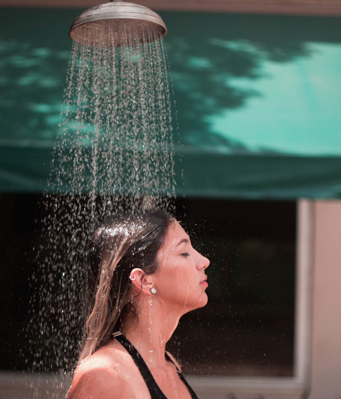 Girl having shower after a long day of exploring] Source: Laura Marques on unsplash.com