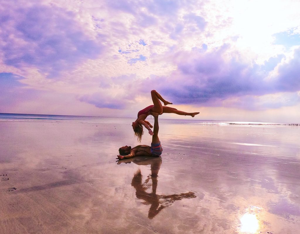 solo travel couple doing yoga