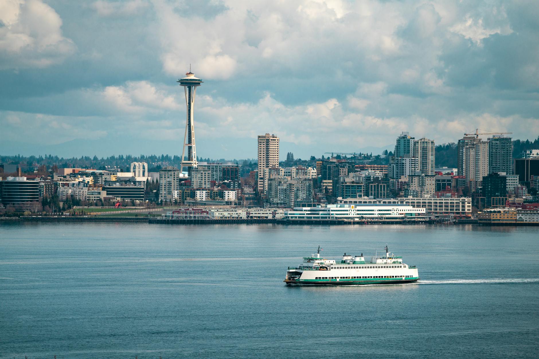 cityscape of seattle with ship sailing by