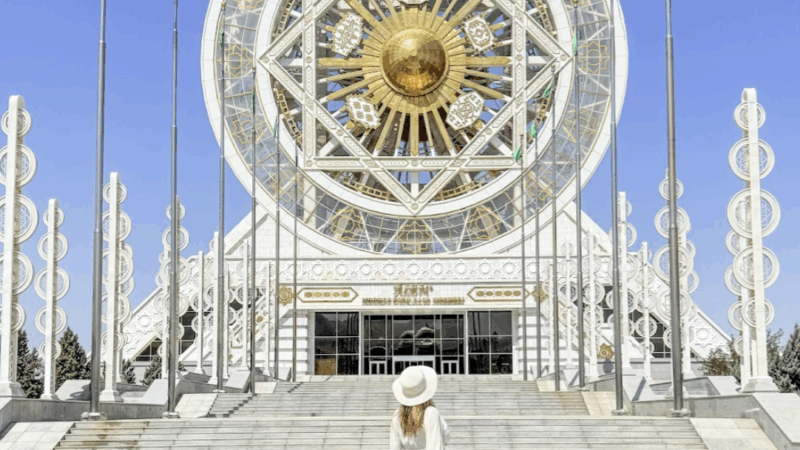 travel blogger Alyssa Ramos @mylifesatravelmovie in front of the ferris wheel in Turkmenistan Ashgabat