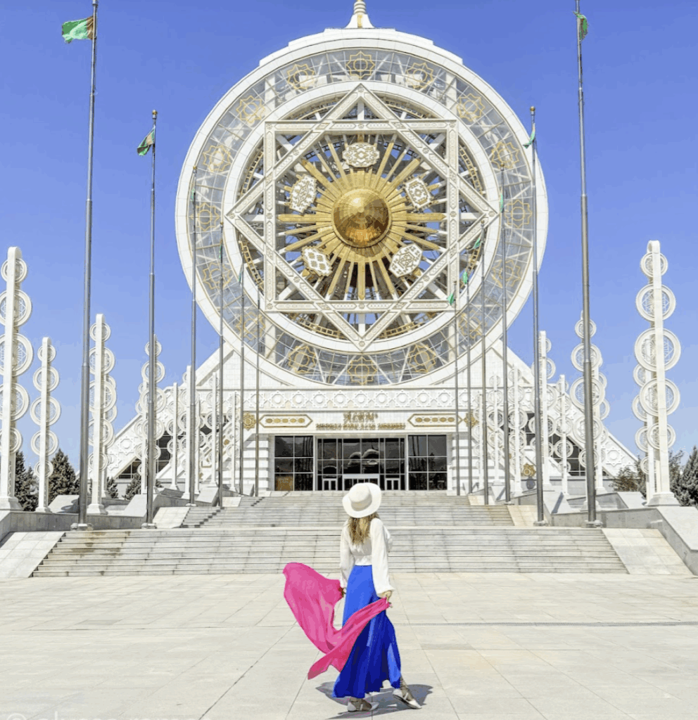 travel blogger Alyssa Ramos @mylifesatravelmovie in front of the ferris wheel in Turkmenistan Ashgabat