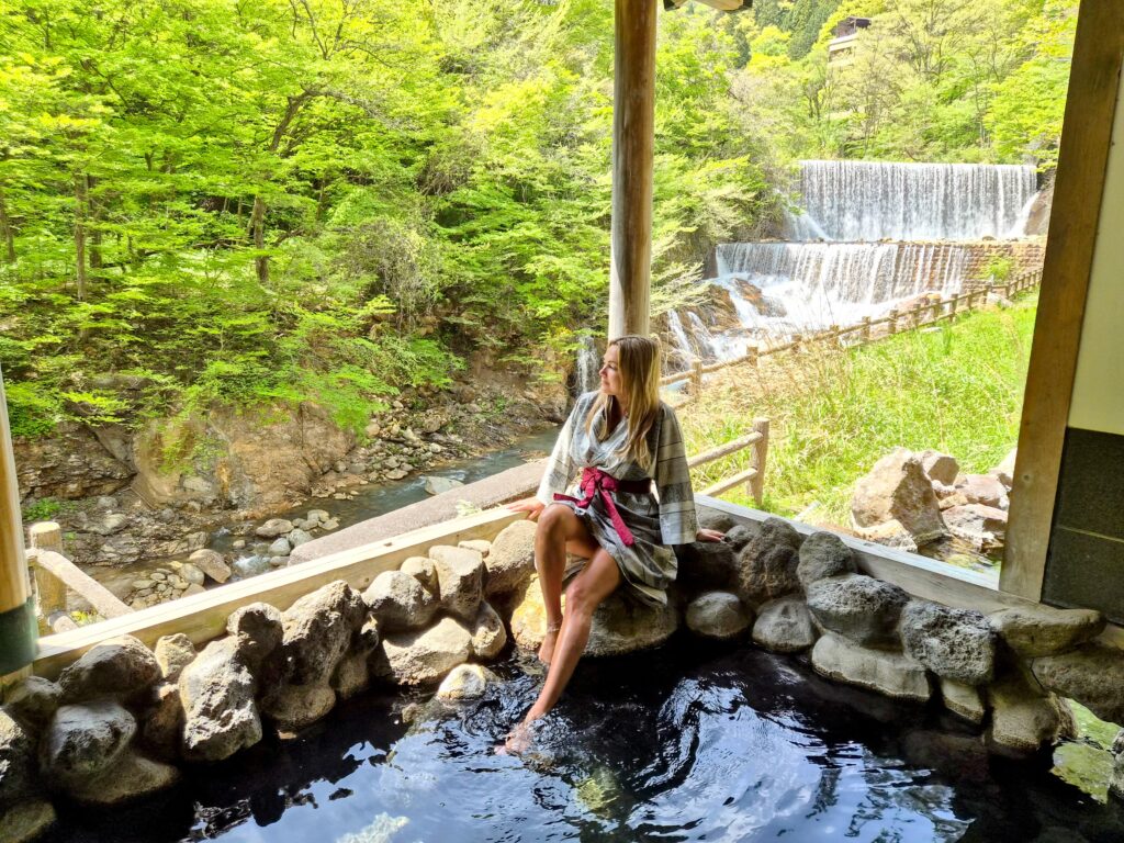 An onsen overlooking a waterfall in Fukushima Japan by travel blogger Alyssa Ramos of MyLifesAMovie.com
