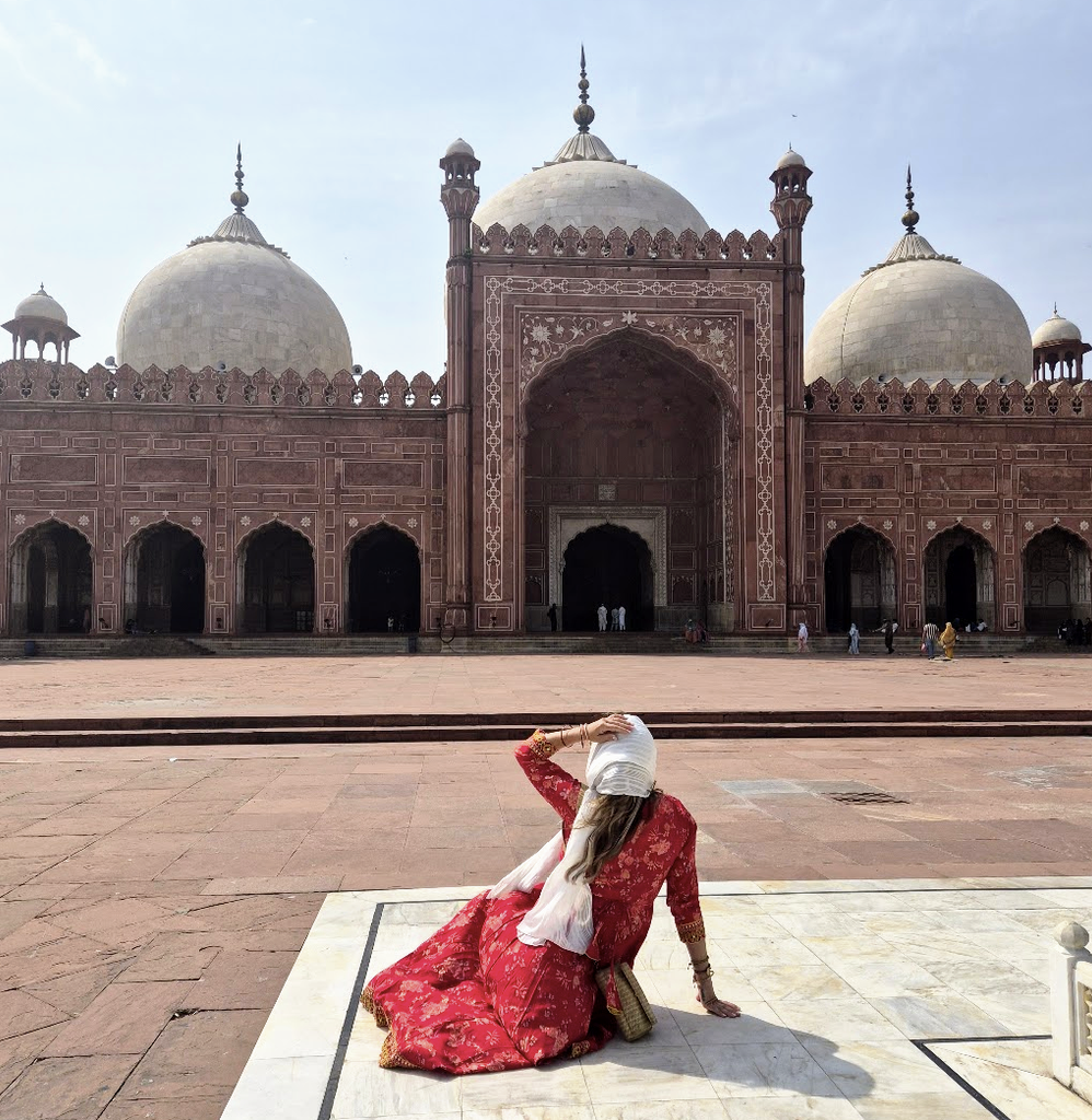 Solo female travel influencer Alyssa Ramos (@mylifesatravelmovie)  exploring the Badshahi Mosque in Lahore Pakistan
