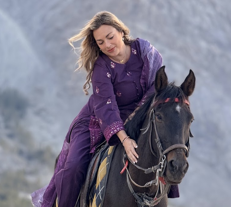 Solo female travel influencer Alyssa Ramos (@mylifesatravelmovie)  horseback riding in the Cold Desert (Shigar Desert) in Skardu Pakistan.