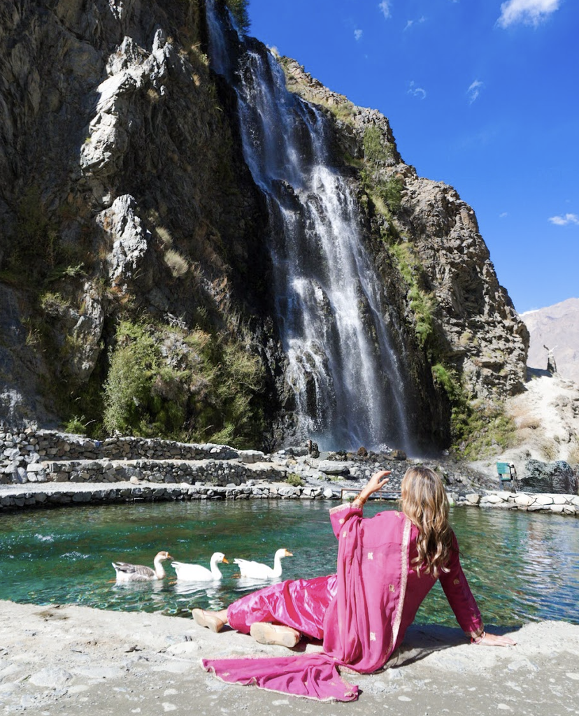 Solo female travel influencer Alyssa Ramos (@mylifesatravelmovie) at Manthokha waterfall in Skardu, Pakistan. MyLifesAMovie.com